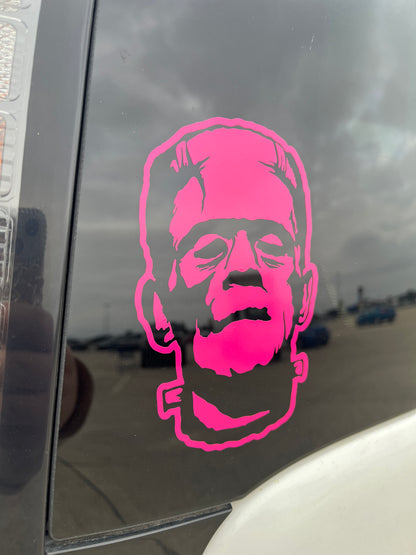 Hot pink Frankenstein decal on the back of a car